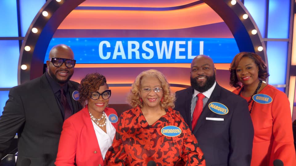 Carswell Family Pose on television set