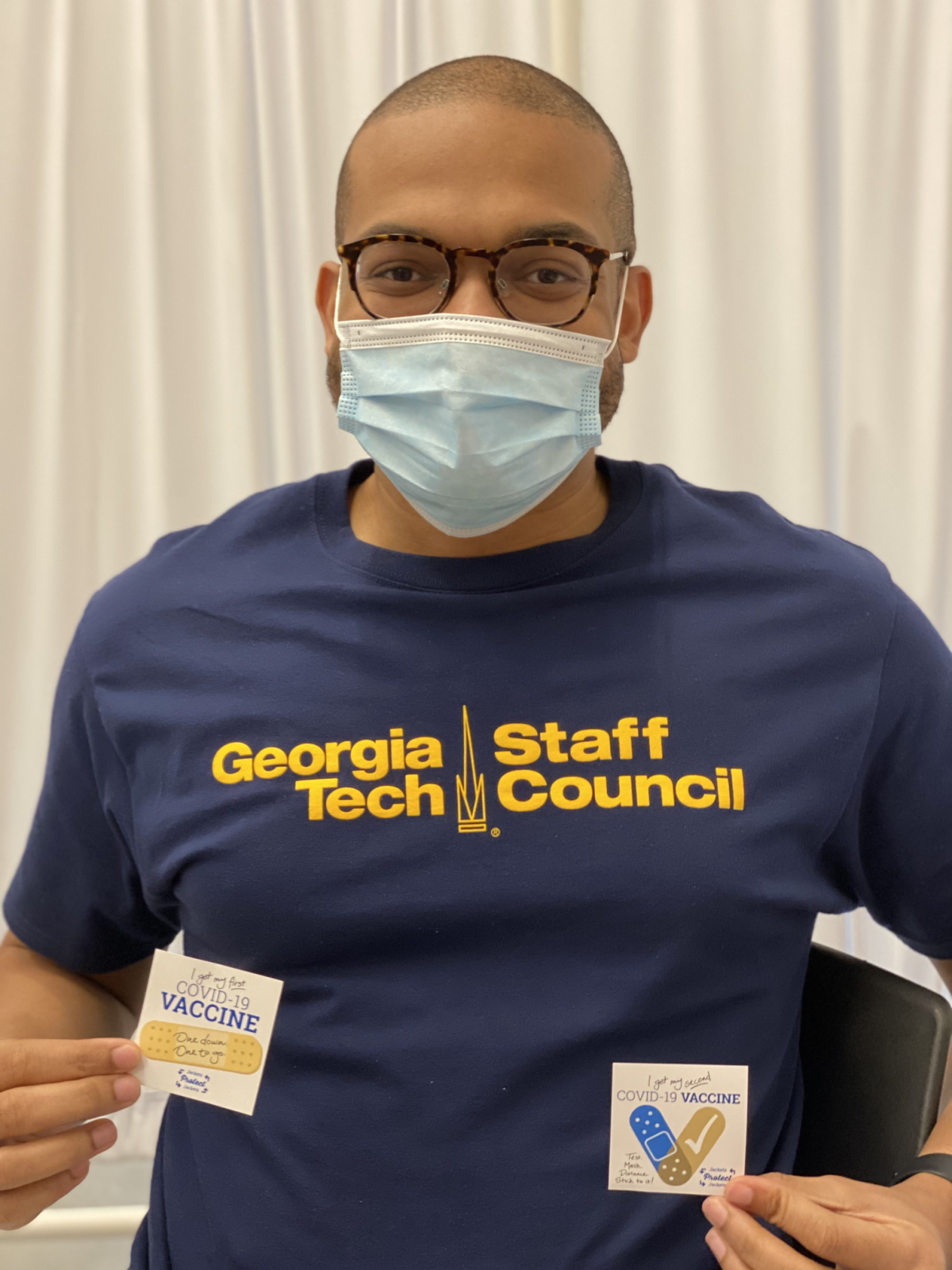 Photo of man in a shirt that says Staff Council and mask